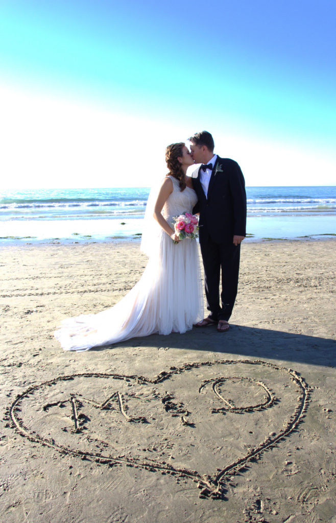 beach wedding ceremony, bride and groom on beach, beach wedding venue, toes in sanding wedding