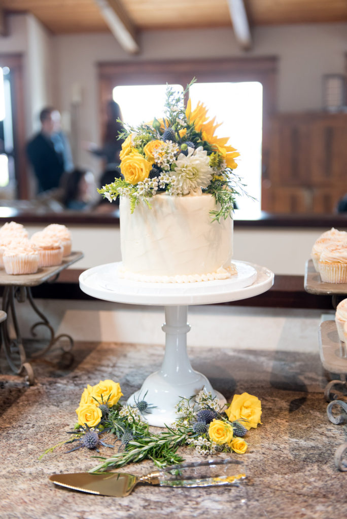 wedding cake, yellow flowers, sunflower and rose cake topper