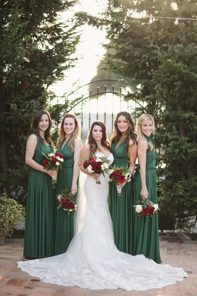 bride and bridesmaids, red bouquet, green bridesmaid dresses