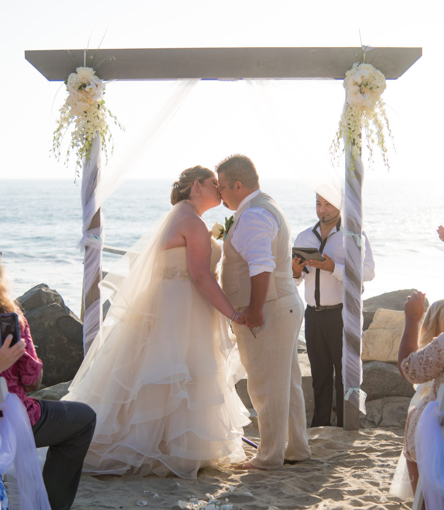 bride and groom first kiss, beach wedding, toes in sand wedding