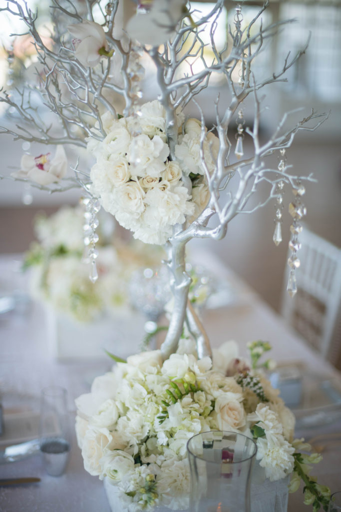 white centerpiece, orchids, hydrangea, silver branches, white and silver flowers