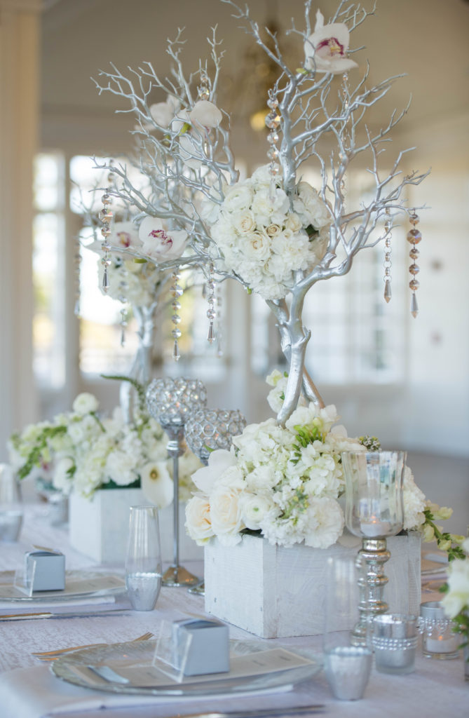 white centerpiece, orchids, hydrangea, silver branches, white and silver flowers