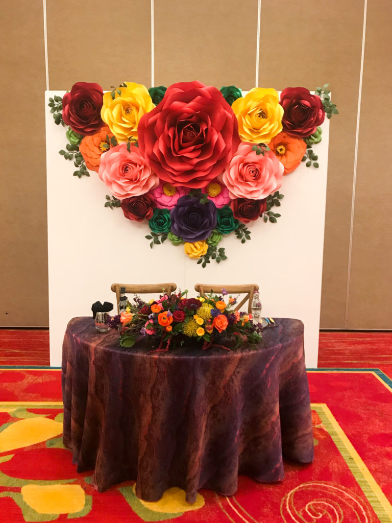 dia de los muertos sweetheart table, day of the dead wedding, flower paper wall, vibrant coloful wedding centerpiecesable, 